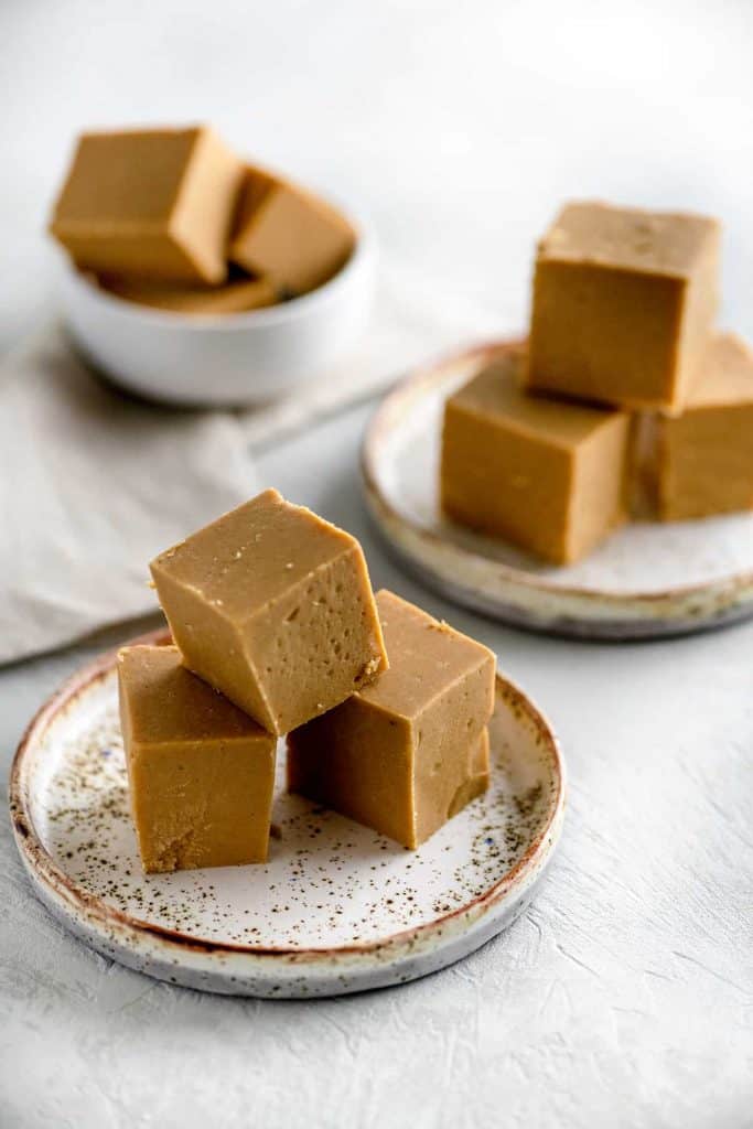 Large squares of peanut butter fudge stacked high on small round plates