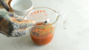 mixing ketchup glaze in a glass bowl