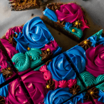 Squares of dr pepper brownies frosted with beautiful rainbow of frosting colors of rosettes and stars.