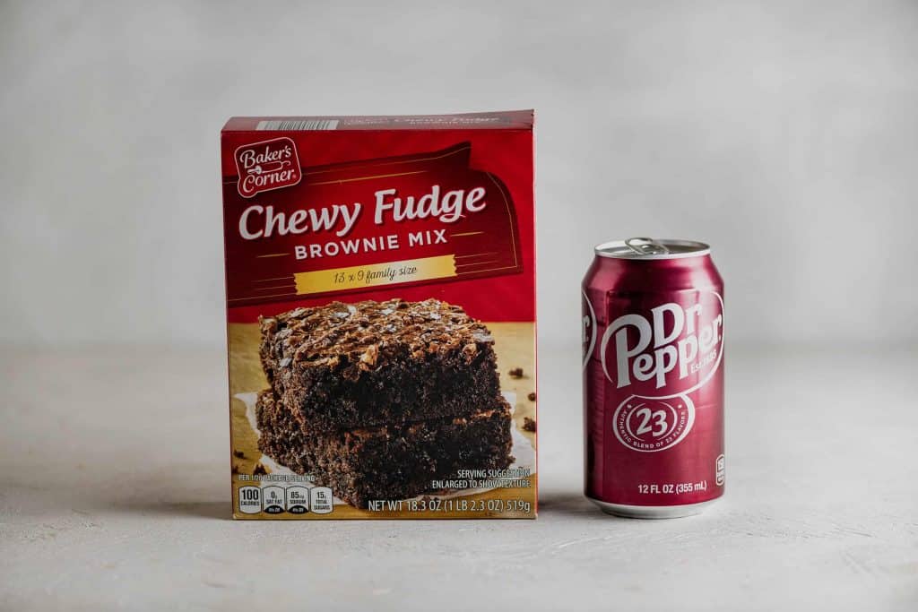 gray table with box of brownie mix and a can of dr pepper