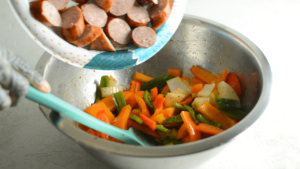 mixing bowl with peppers, onions and sausage