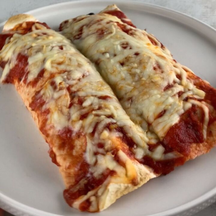 rolled tortilla “lasagna” enchiladas with meat sauce and cheese (high-protein)