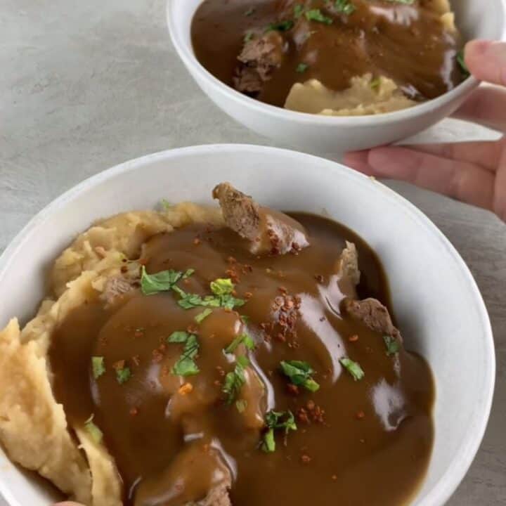 high-protein slow cooker beef stew with gravy and potatoes in a bowl